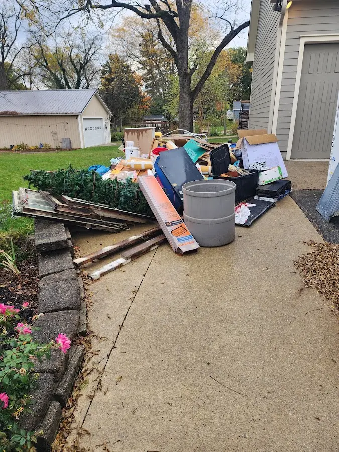 Dumpster being loaded with debris for Residential Dumpster Rental in Highland Park